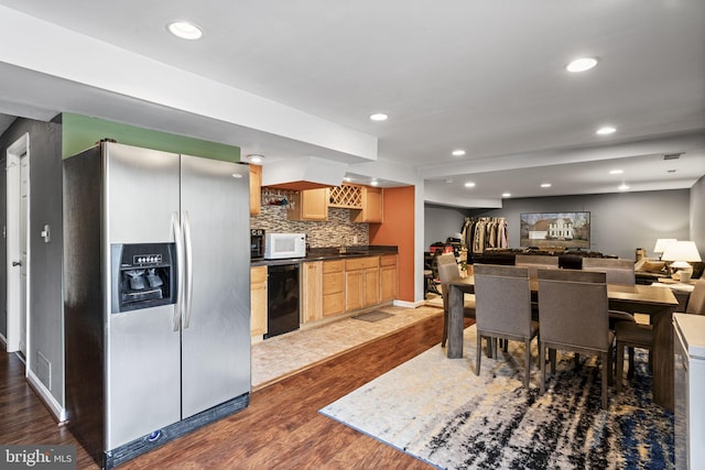 kitchen featuring backsplash, stainless steel fridge, light brown cabinets, and light wood-type flooring