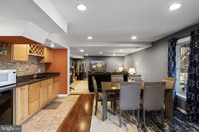 dining area with wine cooler, wet bar, light tile patterned flooring, and a wealth of natural light