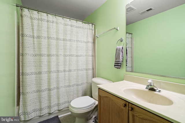 bathroom with vanity, curtained shower, and toilet