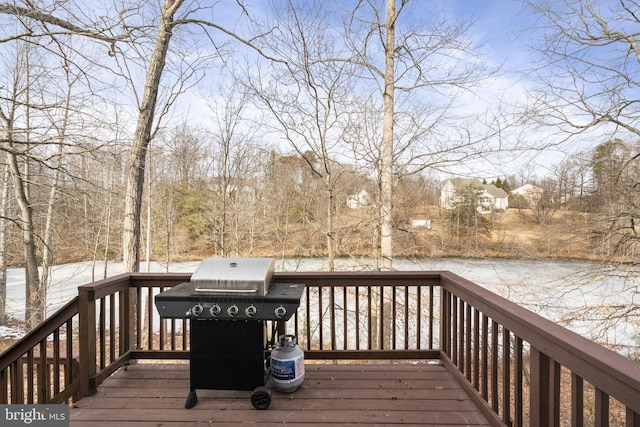 wooden deck featuring a grill