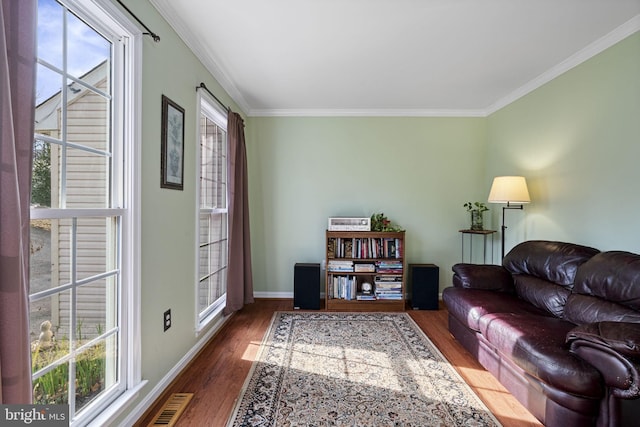 living room with dark wood-type flooring and ornamental molding