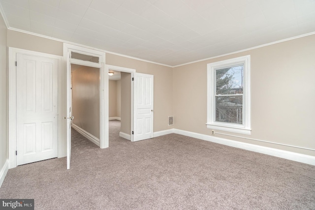 unfurnished bedroom with crown molding and carpet floors