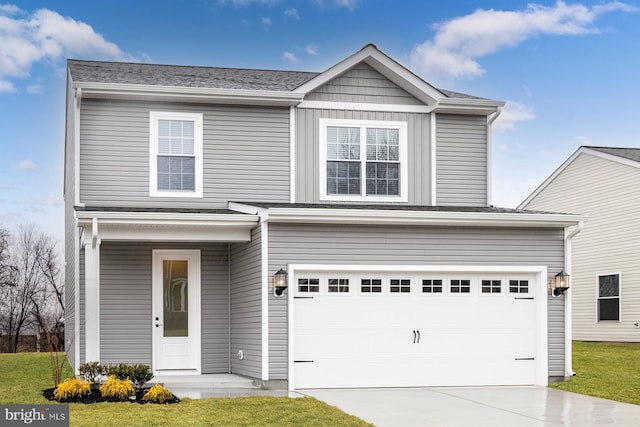 view of property with a garage and a front yard