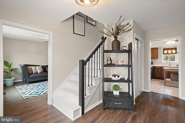 stairway featuring wood finished floors and baseboards