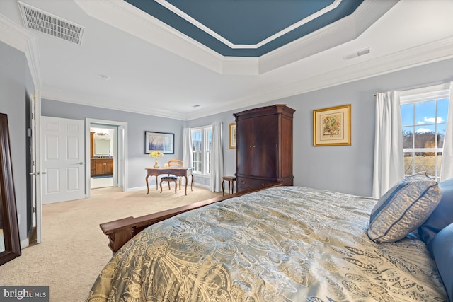 carpeted bedroom with a tray ceiling, multiple windows, and visible vents