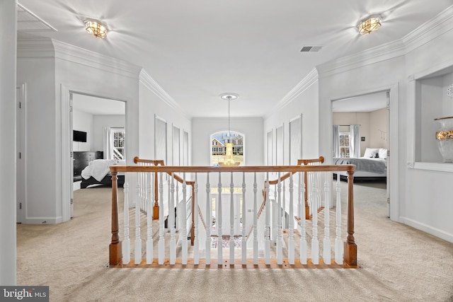 corridor with carpet floors, an inviting chandelier, and an upstairs landing