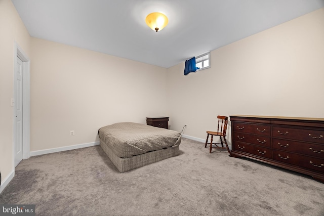 carpeted bedroom featuring baseboards