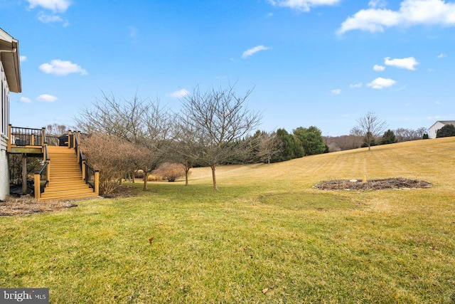 view of yard featuring a deck and stairway