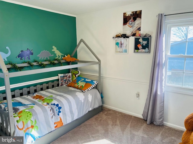 carpeted bedroom featuring baseboards