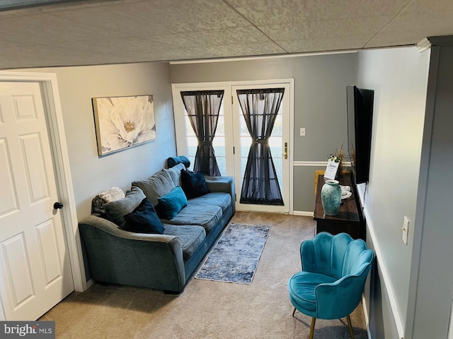 living area with light carpet and baseboards