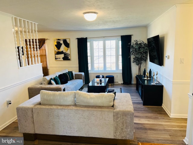 living room with crown molding, wood finished floors, and baseboards