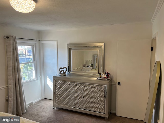 carpeted bedroom with crown molding and a textured ceiling