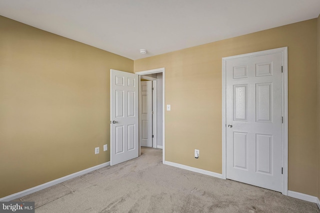 unfurnished bedroom featuring light colored carpet