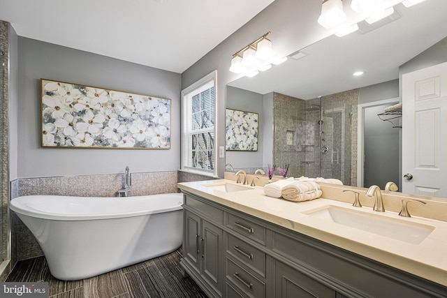 bathroom featuring independent shower and bath, vanity, and tile walls