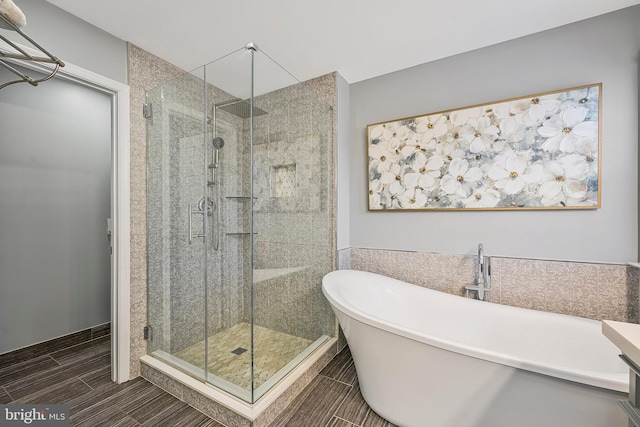 bathroom featuring shower with separate bathtub and vanity