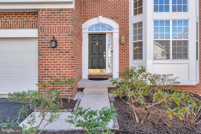 view of exterior entry with a garage