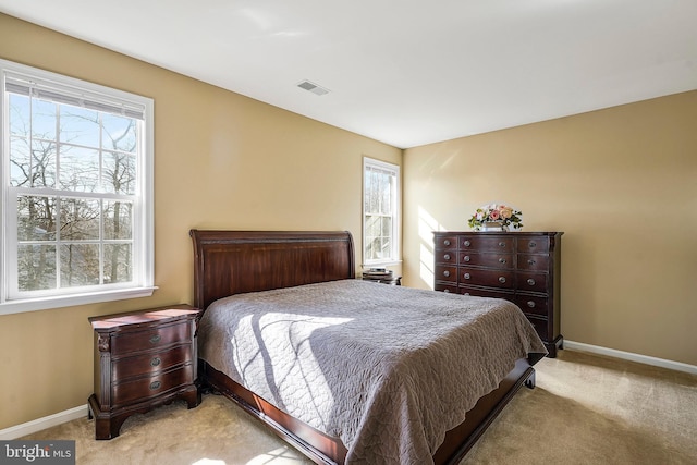 bedroom featuring light carpet