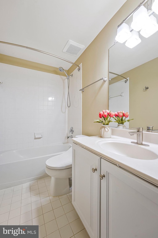 full bathroom featuring tile patterned floors, vanity, toilet, and tiled shower / bath combo