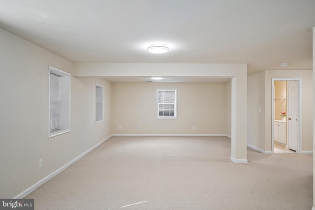 basement featuring light colored carpet