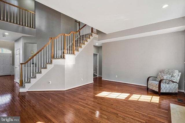 interior space featuring hardwood / wood-style floors and a high ceiling