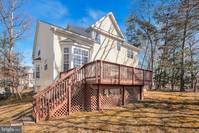 rear view of property featuring a yard and a deck