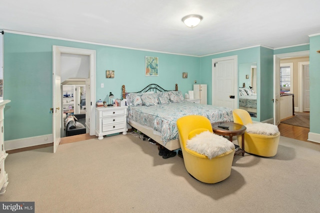 carpeted bedroom featuring crown molding and a closet