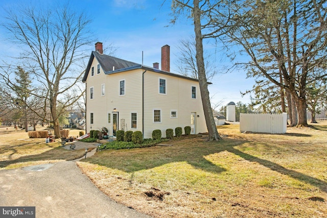 view of home's exterior with a yard