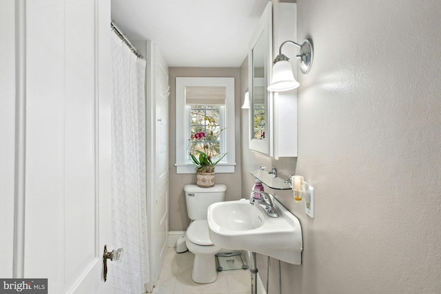 bathroom with tile patterned flooring and toilet