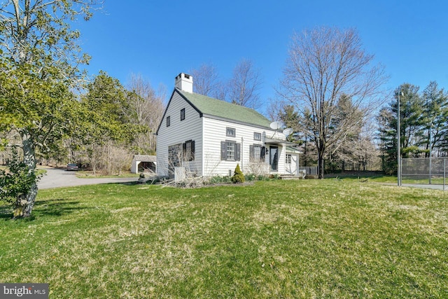 view of side of property with a lawn