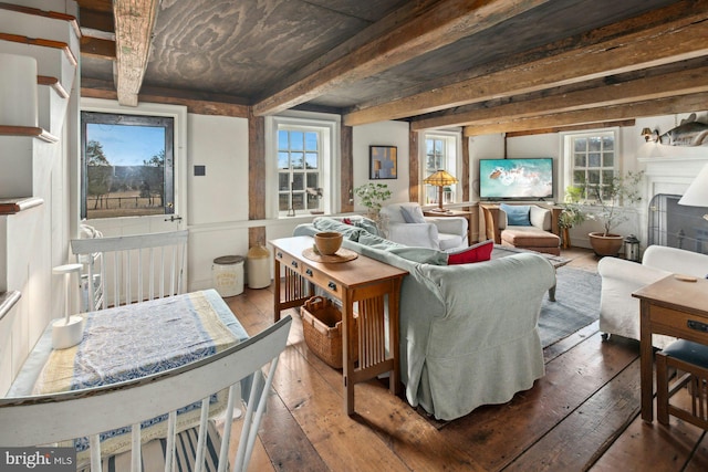 sitting room with hardwood / wood-style flooring and beamed ceiling