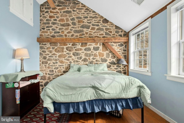 bedroom featuring lofted ceiling and hardwood / wood-style flooring