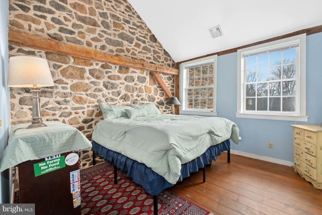 bedroom with hardwood / wood-style flooring and lofted ceiling