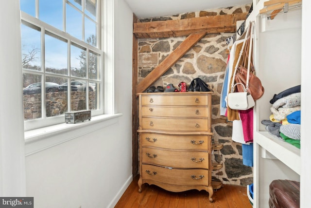 walk in closet with hardwood / wood-style flooring