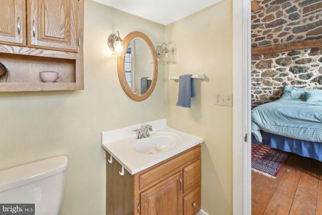 bathroom with vanity, hardwood / wood-style floors, and toilet