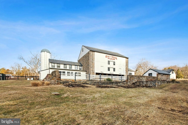 rear view of property with a yard