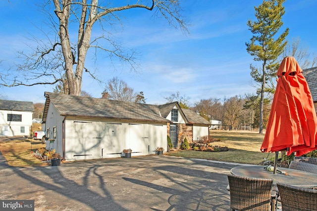 exterior space featuring a garage and an outdoor structure