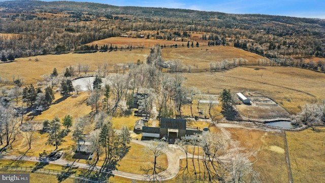 birds eye view of property featuring a water view and a rural view