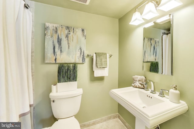 bathroom featuring tile patterned flooring, sink, and toilet