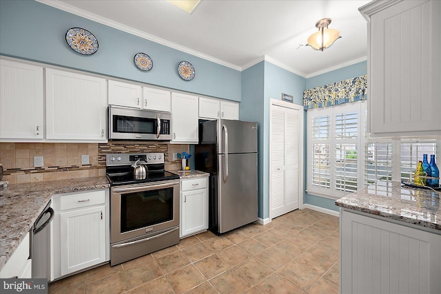 kitchen featuring decorative backsplash, crown molding, white cabinetry, and stainless steel appliances