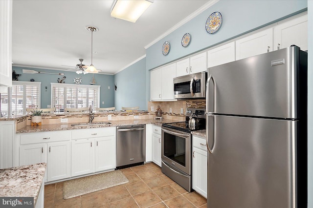 kitchen with a ceiling fan, a sink, white cabinetry, appliances with stainless steel finishes, and crown molding