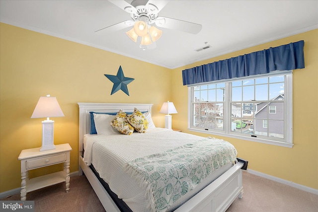 bedroom featuring visible vents, a ceiling fan, carpet, crown molding, and baseboards