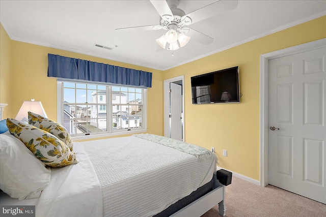 carpeted bedroom with a ceiling fan, baseboards, visible vents, and ornamental molding