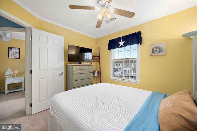 bedroom featuring a ceiling fan, visible vents, carpet floors, and ornamental molding