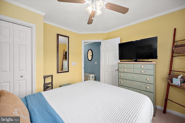 carpeted bedroom featuring crown molding, baseboards, a closet, and ceiling fan