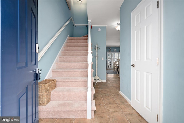 stairs with tile patterned flooring and baseboards