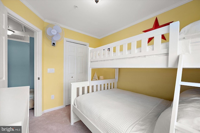 bedroom with a closet, carpet floors, baseboards, and ornamental molding