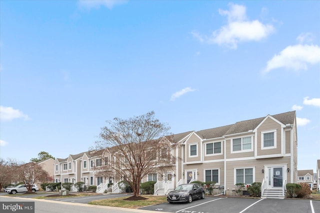 view of front of home featuring a residential view and uncovered parking