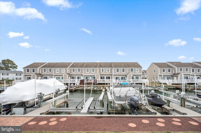 dock area featuring a residential view, boat lift, and a water view