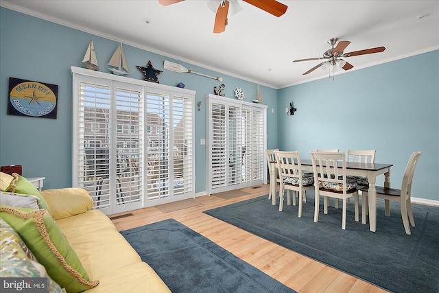 dining space with ornamental molding, wood finished floors, baseboards, and ceiling fan