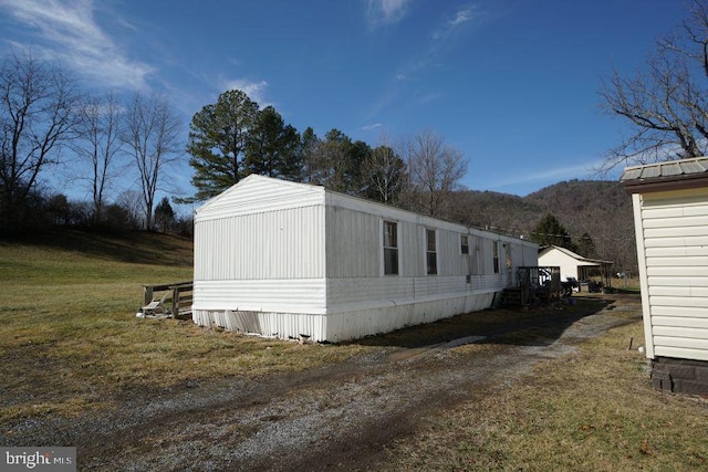 view of side of property with a lawn